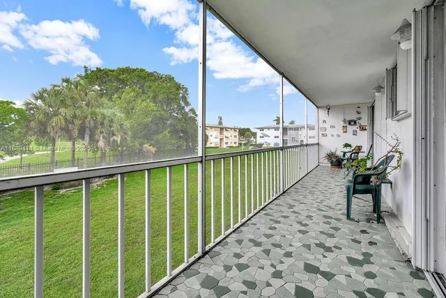 a view of a balcony with chair and wooden floor