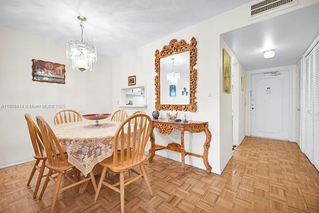 a view of a dining room with furniture and chandelier
