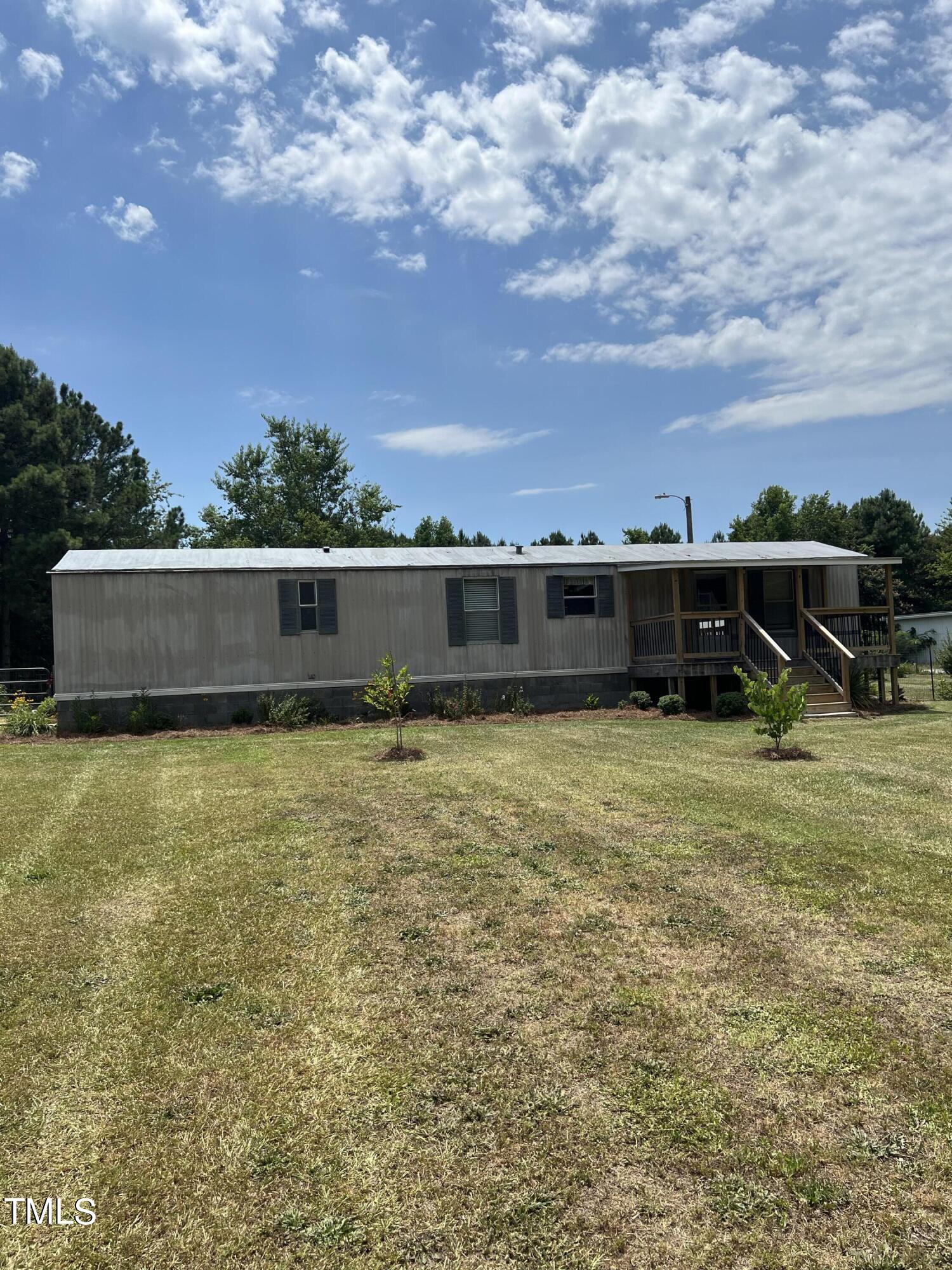 7729 Strickland Road Bailey, NC 27807 - Photo 1 of 8 a view of a big yard with a house