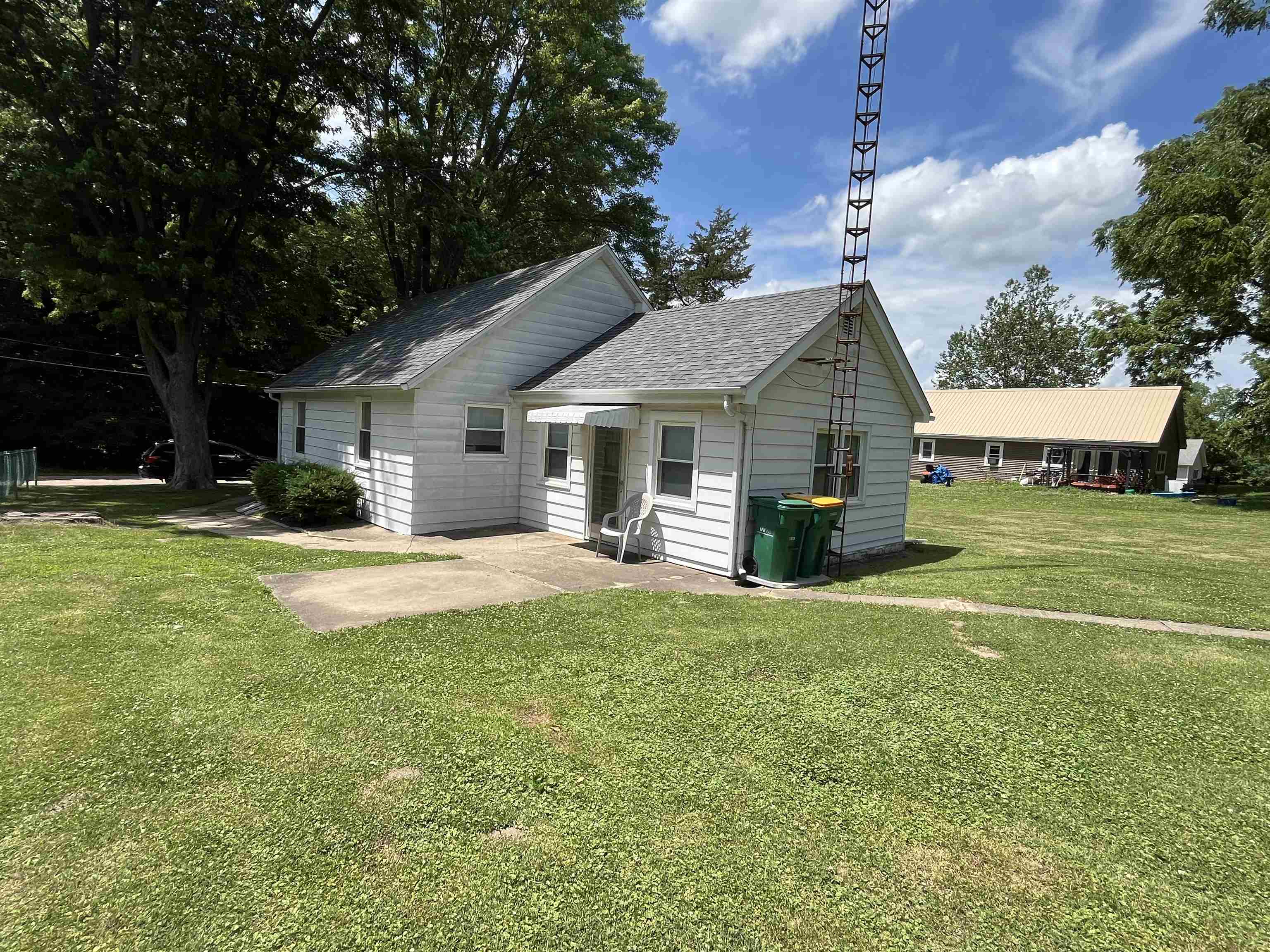 113 3rd Street Mark, IL 61326 - Photo 2 of 9 a front view of a house with a yard porch and outdoor seating