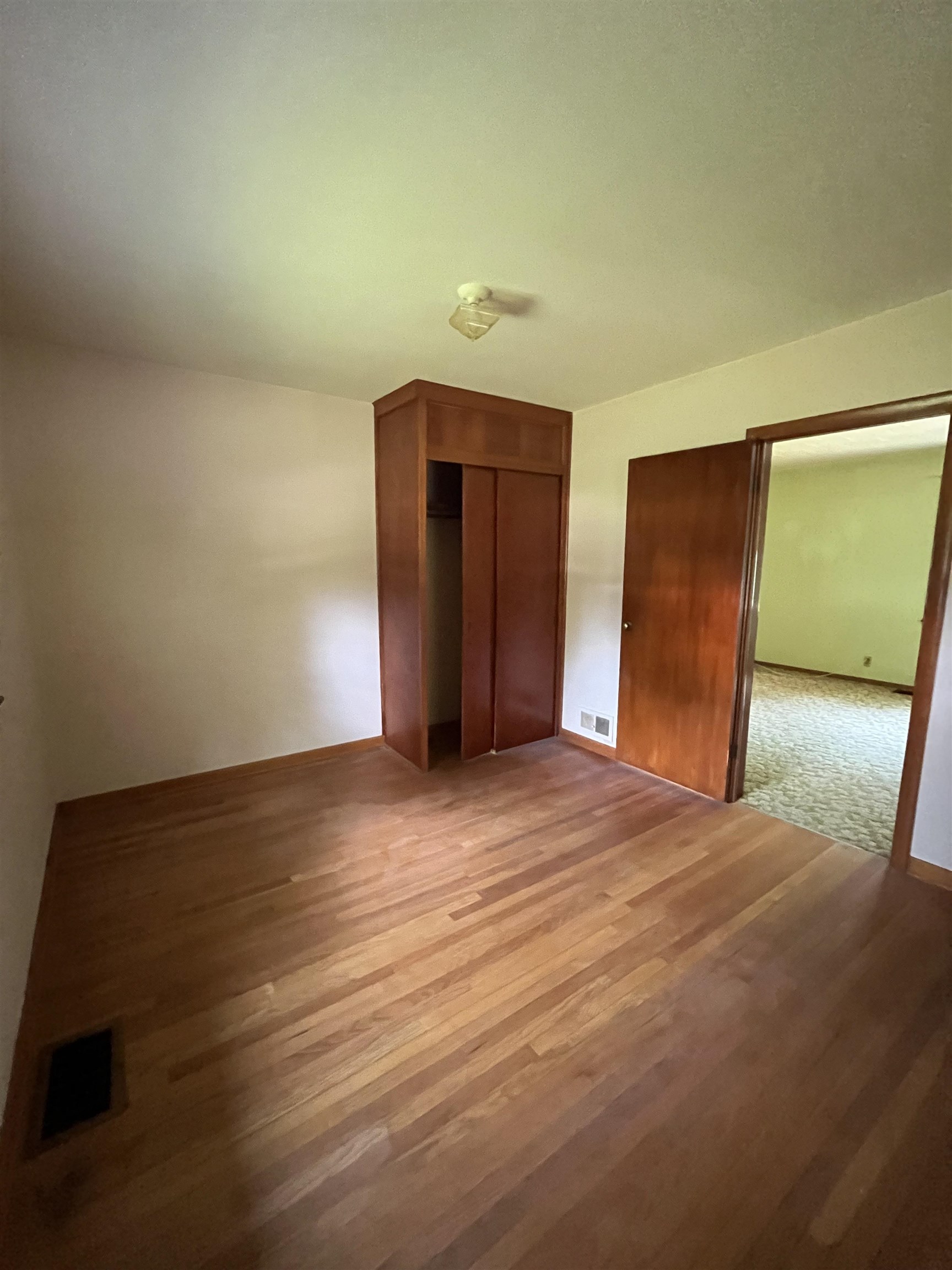 113 3rd Street Mark, IL 61326 - Photo 3 of 9 a view of an empty room with wooden floor and a window