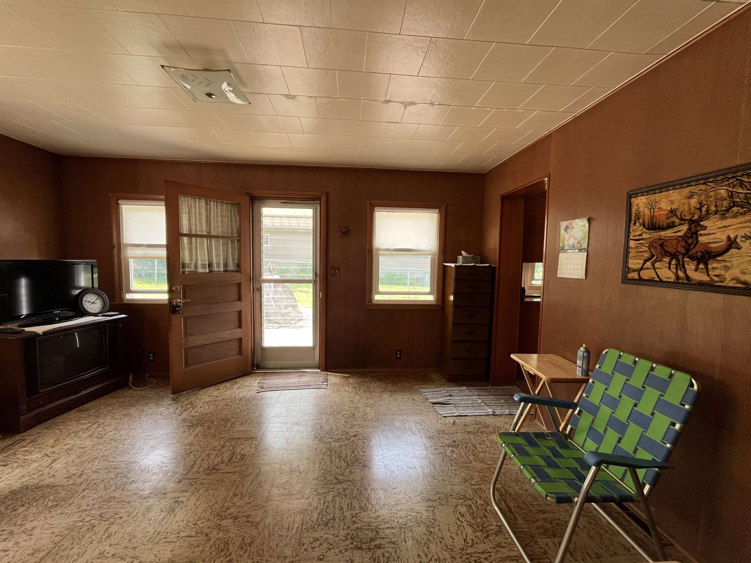 113 3rd Street Mark, IL 61326 - Photo 9 of 9 a view of a livingroom with furniture a kitchen stove and wooden floor