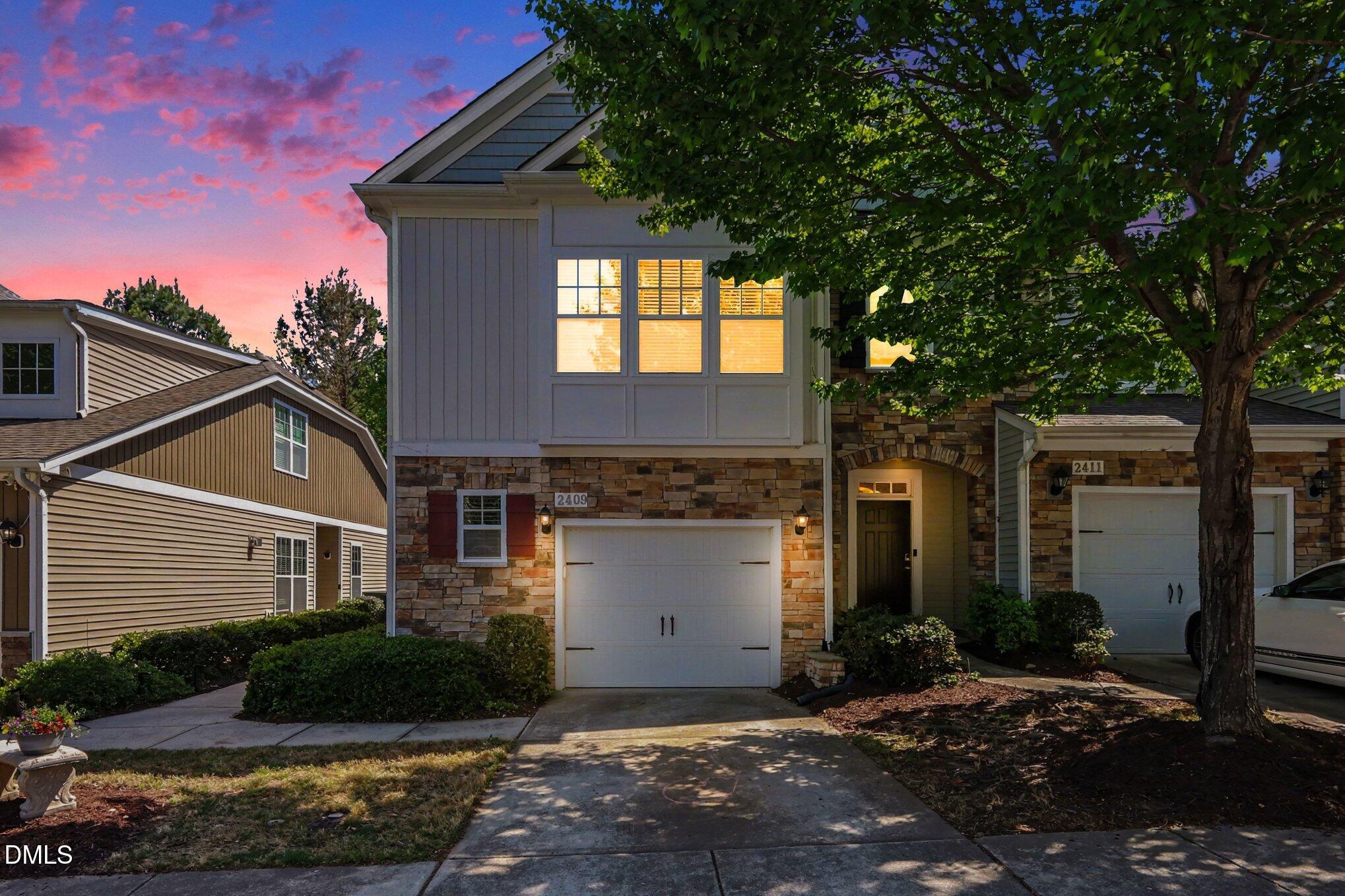 2409 Memory Ridge Drive Raleigh, NC 27606 - Photo 1 of 36 a front view of a house with a garden