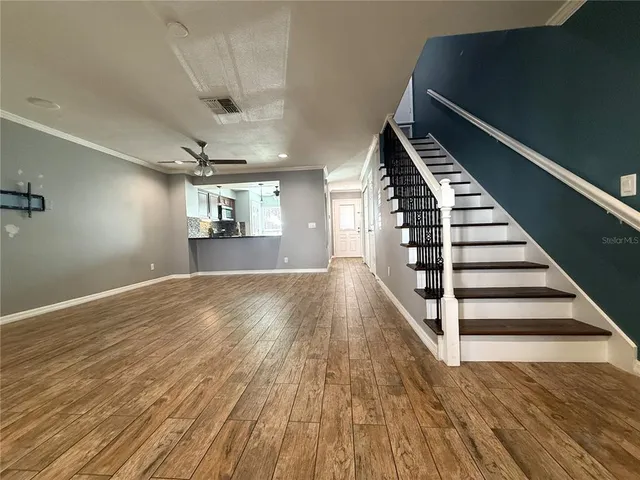 a view of entryway and hall with wooden floor