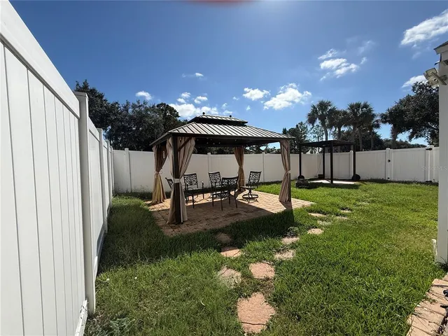 a swimming pool with table and chairs