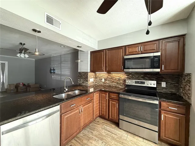 a kitchen with a sink stove and microwave