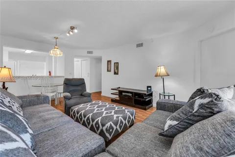 a living room with furniture and a lamp