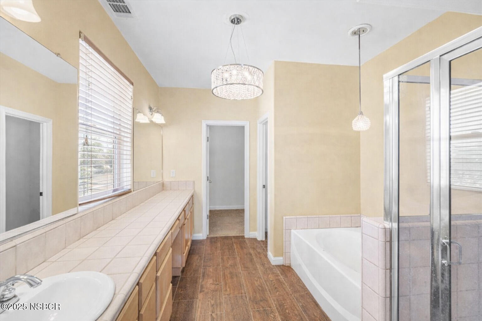 2742 Niverth Place Santa Maria, CA 93455 - Photo 5 of 23 a view of a bathroom with tub wooden floor and windows