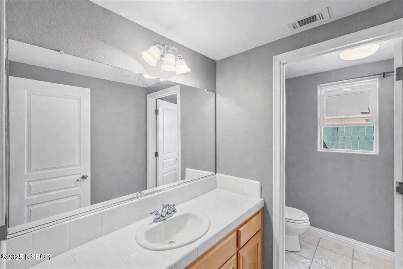 2742 Niverth Place Santa Maria, CA 93455 - Photo 7 of 23 a bathroom with a sink a toilet and a mirror