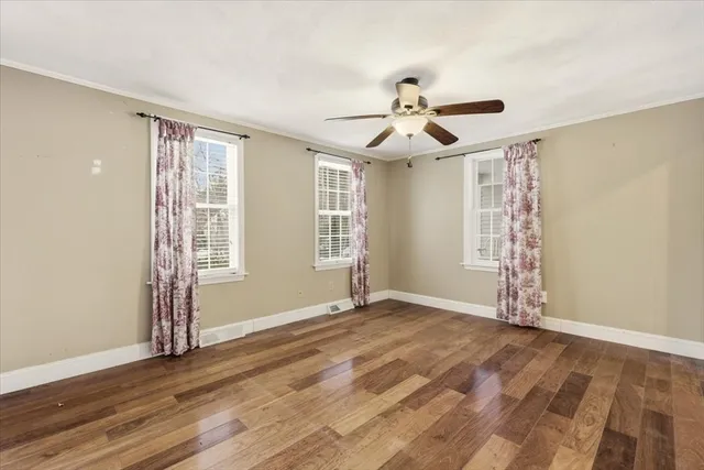 wooden floor in an empty room with a window