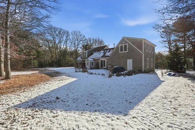 a front view of a house with a yard covered with snow in front of house