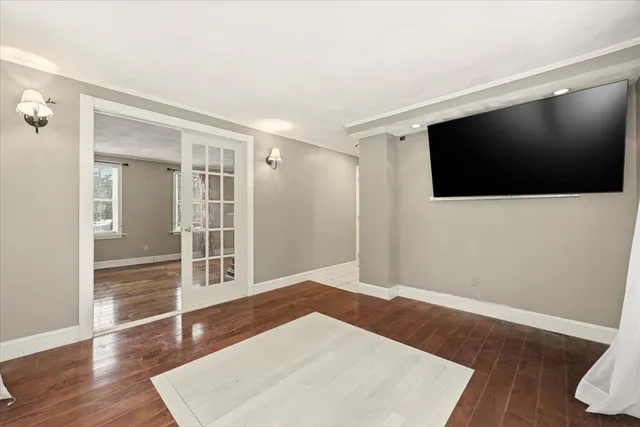 a view of a livingroom with wooden floor and a flat screen tv