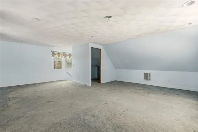 an empty room with a empty space and windows