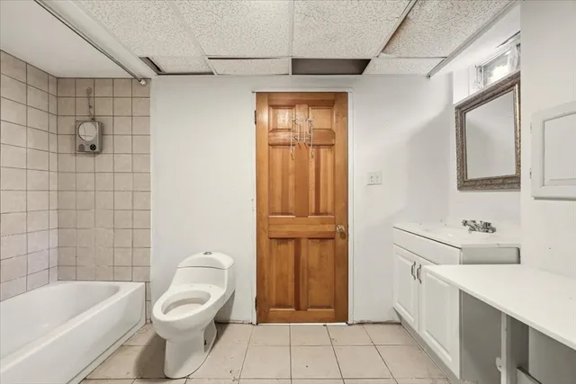 a bathroom with a toilet a sink a bath tub and shower