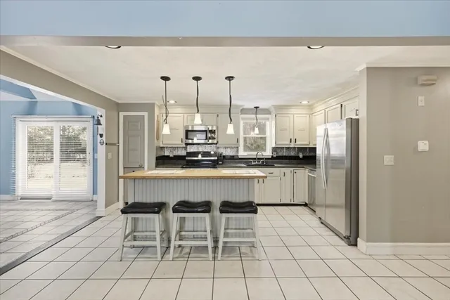a kitchen with stainless steel appliances a refrigerator and cabinets
