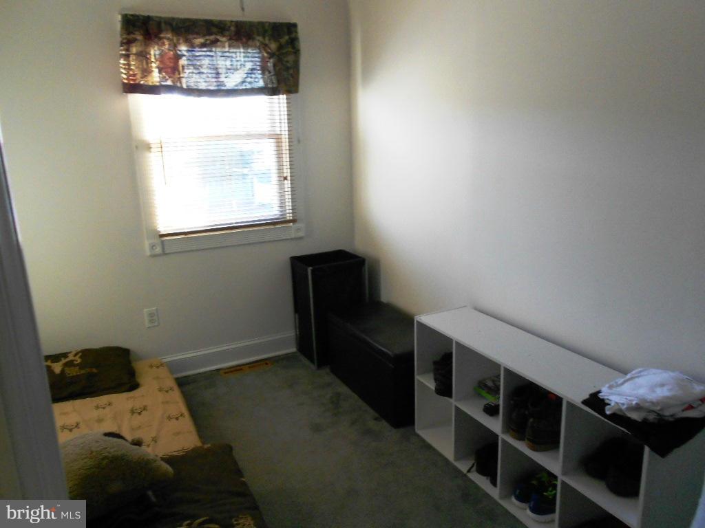 8164 Mid Haven Road Baltimore, MD 21222 - Photo 14 of 27 a room with furniture a window and a potted plant