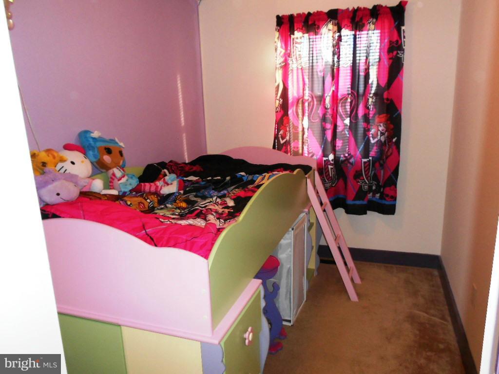 8164 Mid Haven Road Baltimore, MD 21222 - Photo 8 of 27 a bed room with a bed and a window