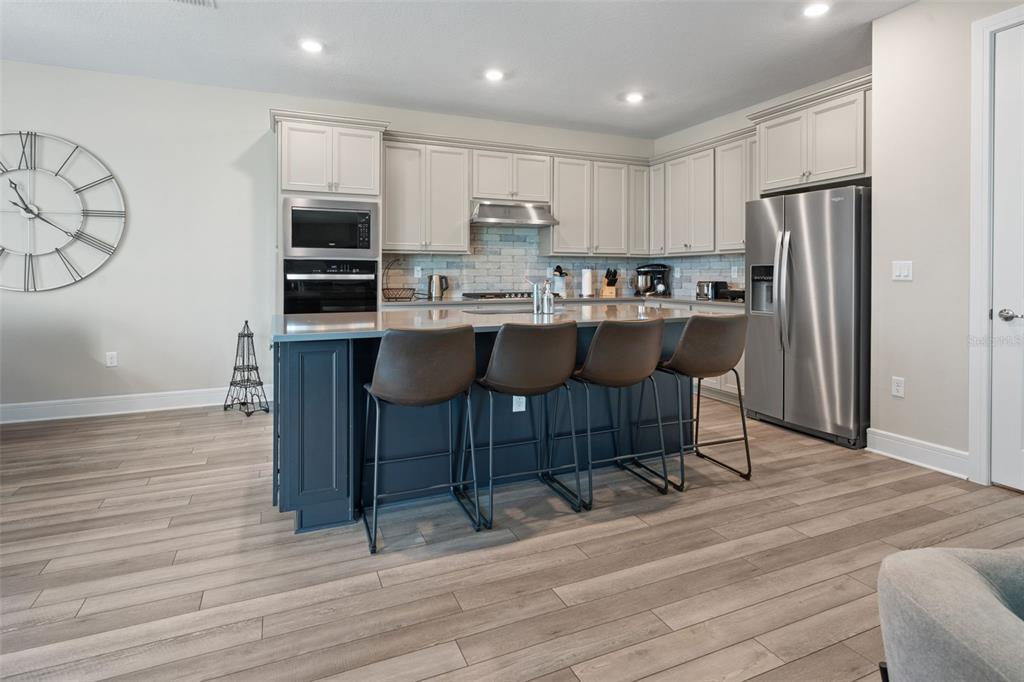 15203 Willow Ridge Drive Montverde, FL 34756 - Photo 20 of 51 a kitchen with stainless steel appliances a sink a stove a refrigerator cabinets and wooden floor