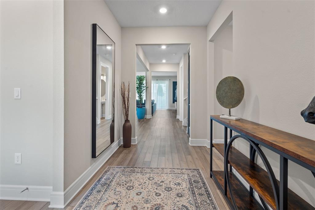 15203 Willow Ridge Drive Montverde, FL 34756 - Photo 2 of 51 a view of a hallway with furniture and wooden floor