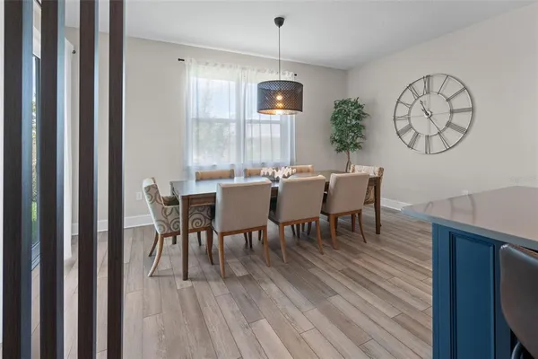 a view of a dining room with furniture window and wooden floor