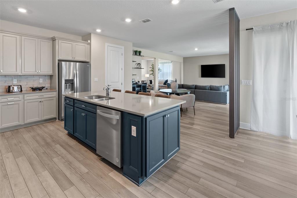 15203 Willow Ridge Drive Montverde, FL 34756 - Photo 27 of 51 a large kitchen with stainless steel appliances granite countertop a table chairs sink and cabinets