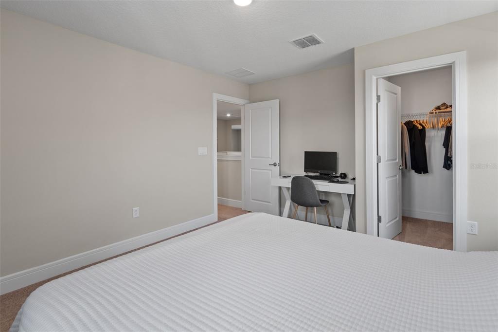 15203 Willow Ridge Drive Montverde, FL 34756 - Photo 31 of 51 a bedroom with a bed and a flat screen tv