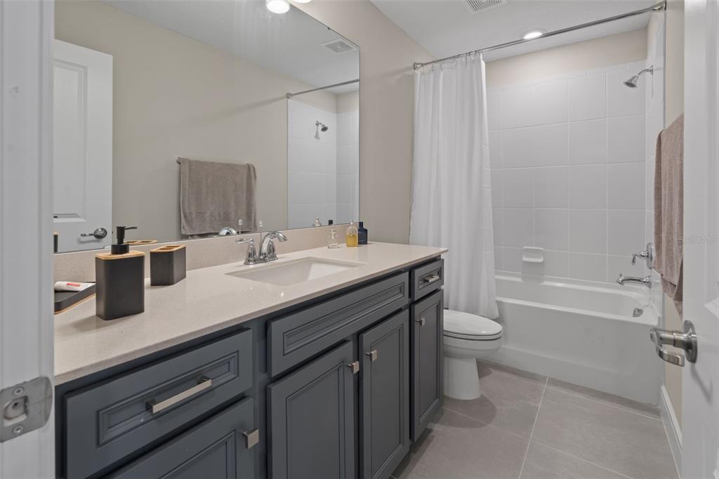 15203 Willow Ridge Drive Montverde, FL 34756 - Photo 32 of 51 a bathroom with a granite countertop sink toilet and shower