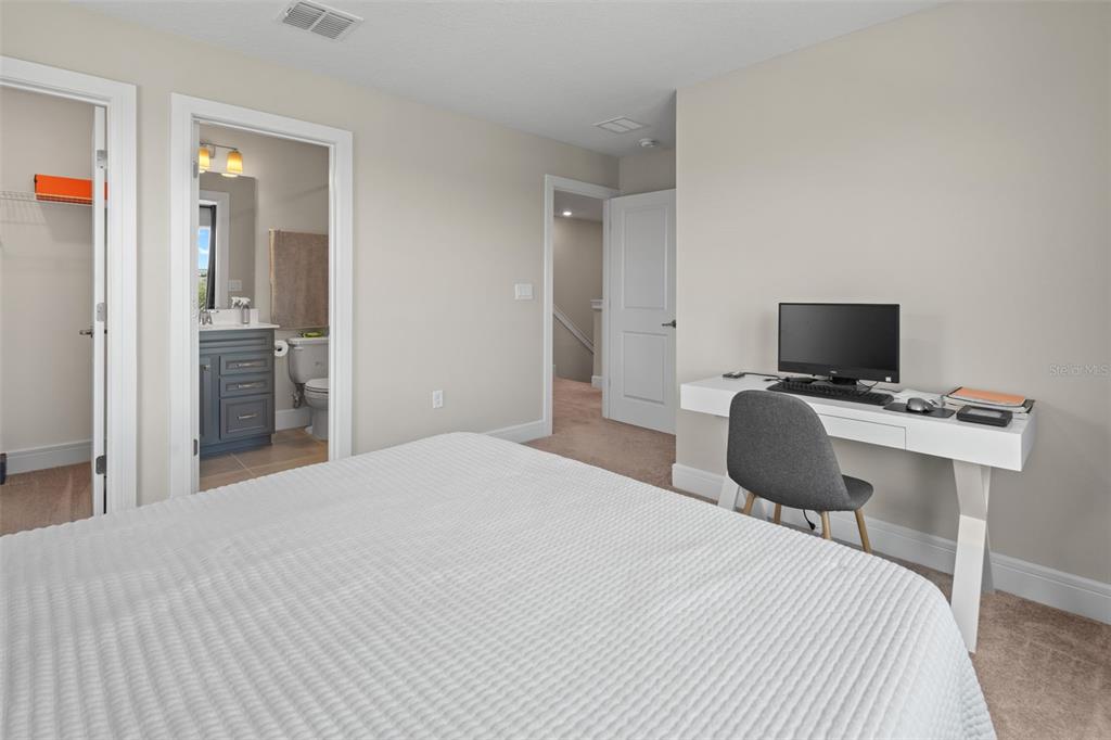 15203 Willow Ridge Drive Montverde, FL 34756 - Photo 35 of 51 a bedroom with a bed and a flat screen tv