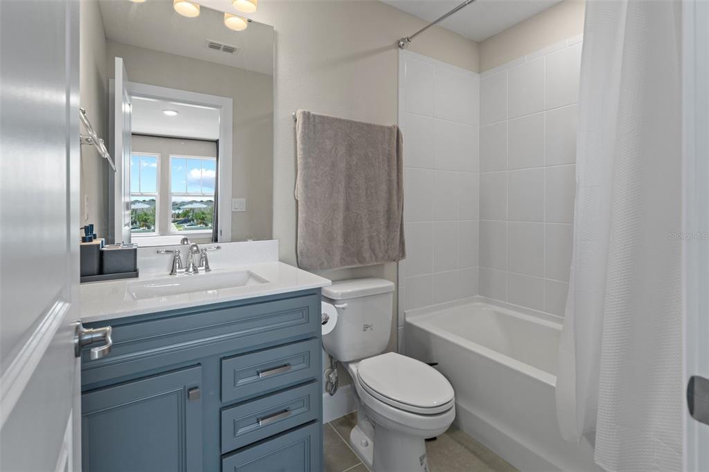 15203 Willow Ridge Drive Montverde, FL 34756 - Photo 36 of 51 a bathroom with a granite countertop sink a toilet and shower