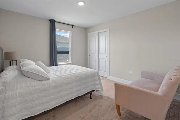 a bedroom with a bed and a couch