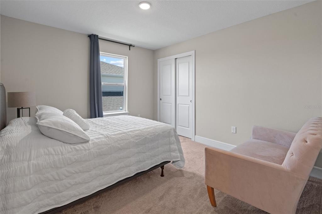 15203 Willow Ridge Drive Montverde, FL 34756 - Photo 37 of 51 a bedroom with a bed and a couch