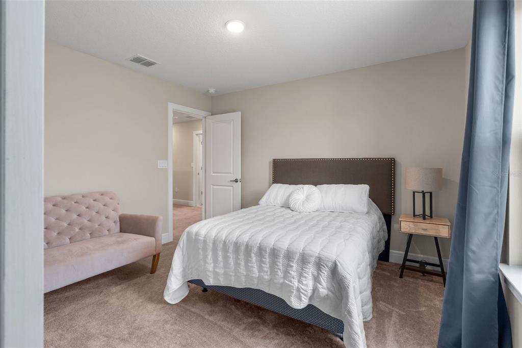 15203 Willow Ridge Drive Montverde, FL 34756 - Photo 38 of 51 a bedroom with a bed and a chair