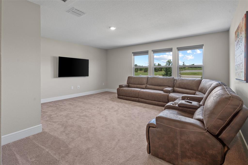 15203 Willow Ridge Drive Montverde, FL 34756 - Photo 39 of 51 a living room with furniture and a flat screen tv