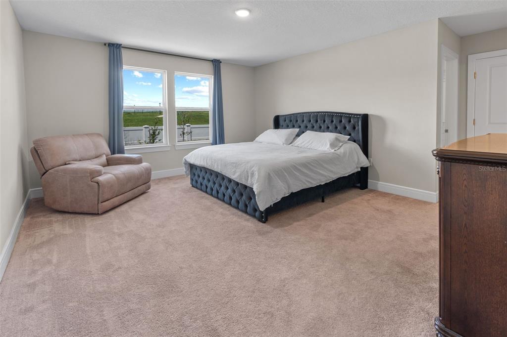 15203 Willow Ridge Drive Montverde, FL 34756 - Photo 42 of 51 a spacious bedroom with a bed and a couch