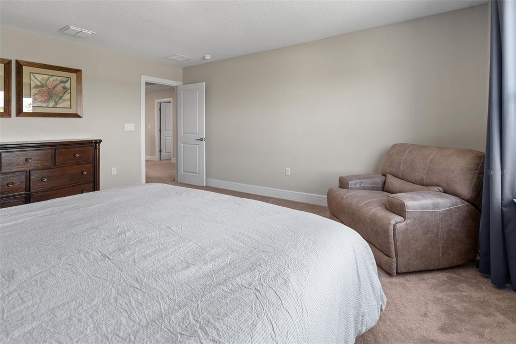 15203 Willow Ridge Drive Montverde, FL 34756 - Photo 43 of 51 a bedroom with a bed and furniture