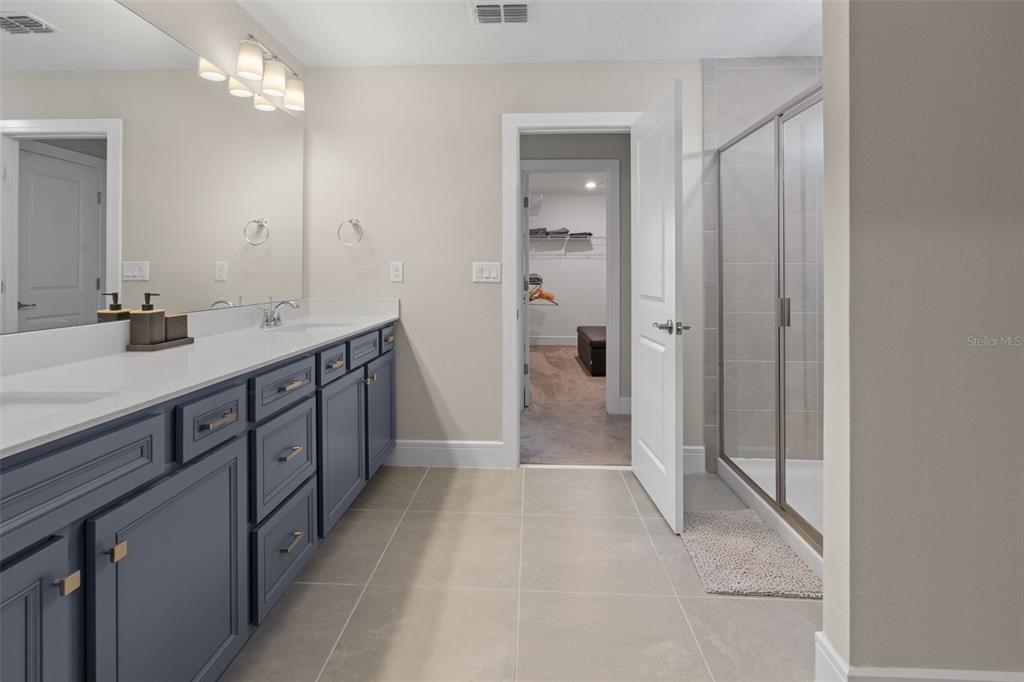 15203 Willow Ridge Drive Montverde, FL 34756 - Photo 46 of 51 a spacious bathroom with a double vanity sink a mirror and a shower