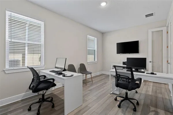 a view of a workspace with a window and lounge chair