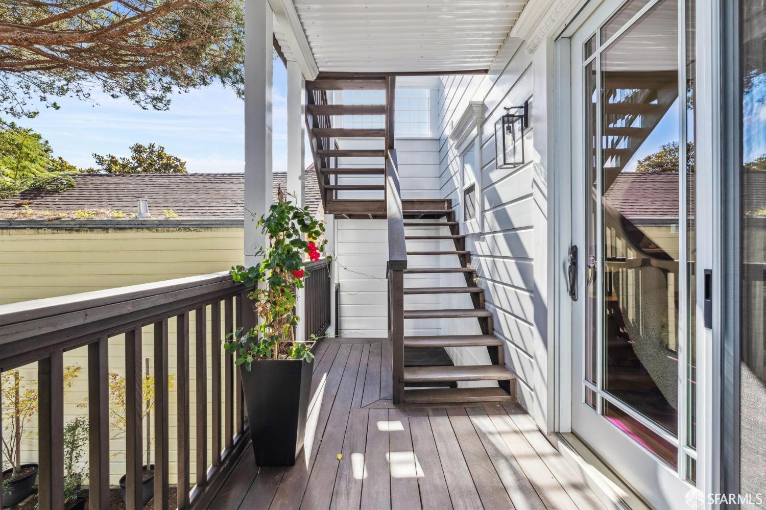 729 Douglass Street San Francisco, CA 94114 - Photo 67 of 92 a view of a balcony with wooden floor and potted plants