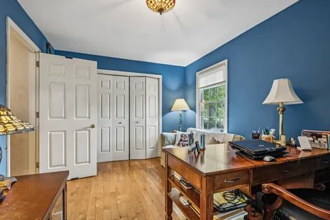 a living room with furniture a piano and a flat screen tv