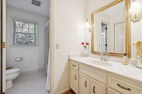 a bedroom with a bed next to a window