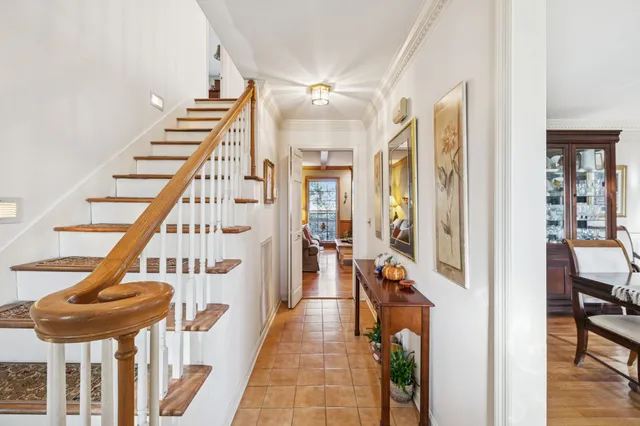 a view of an entryway with wooden floor and a livingroom
