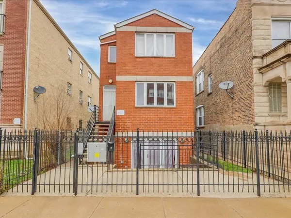 a view of a brick house with many windows