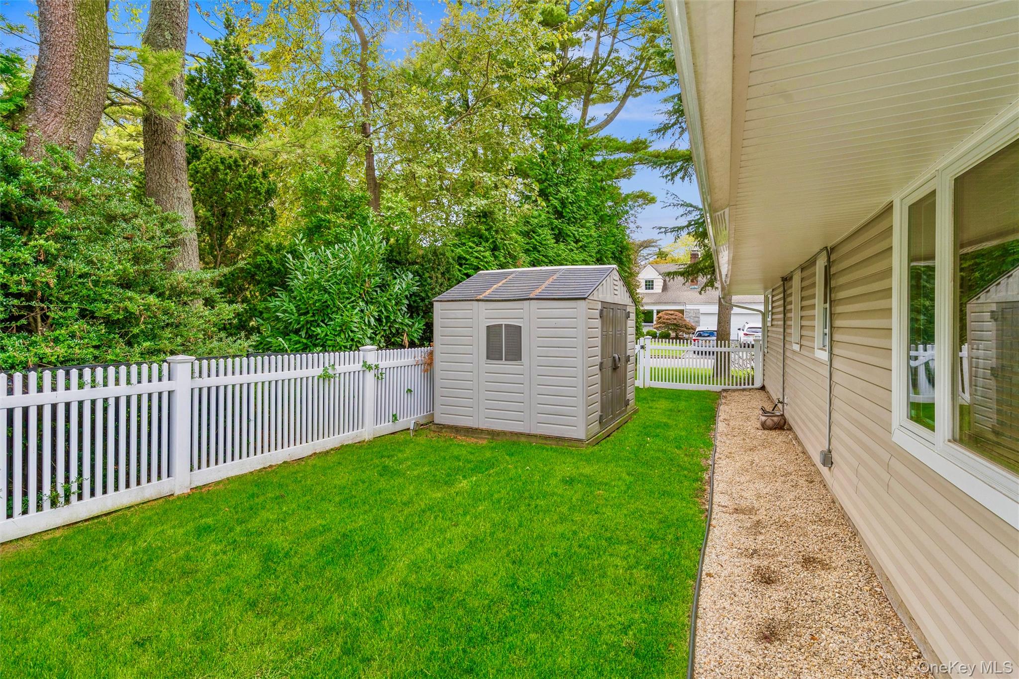 262 Channon Road Hewlett, NY 11557 - Photo 11 of 27 a view of a backyard with wooden fence