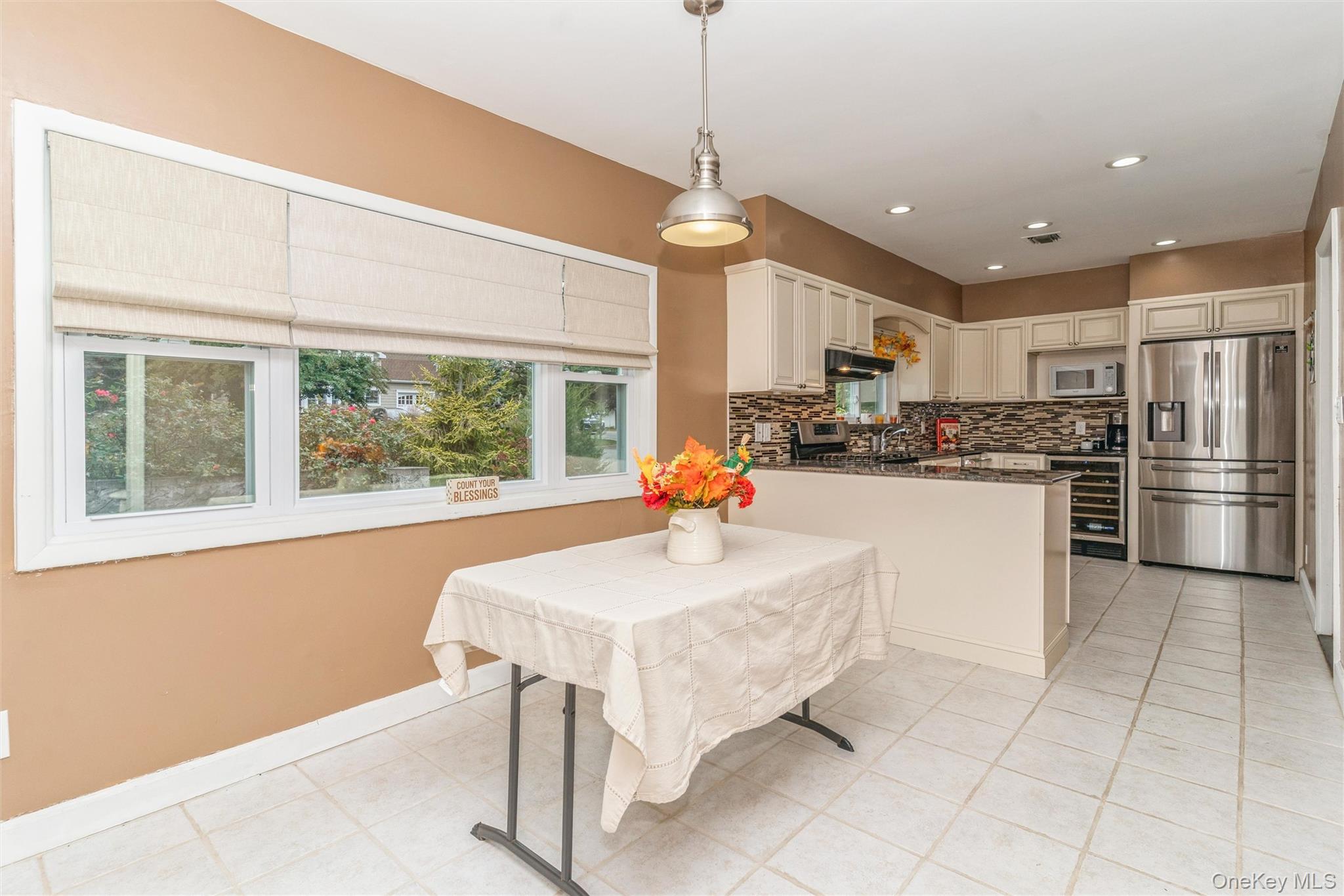 262 Channon Road Hewlett, NY 11557 - Photo 20 of 27 a kitchen with stainless steel appliances kitchen island granite countertop a refrigerator a stove a sink dishwasher and a dining table with wooden floor