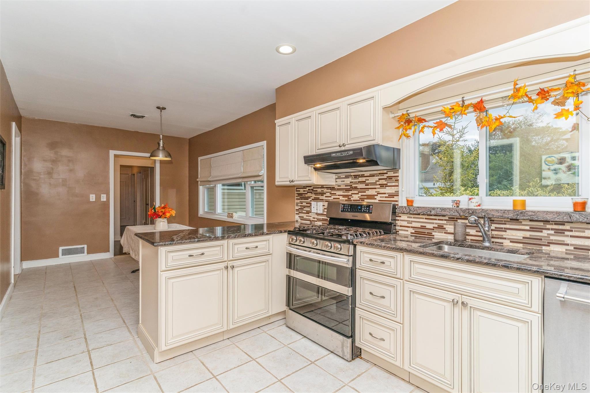 262 Channon Road Hewlett, NY 11557 - Photo 22 of 27 a kitchen with stainless steel appliances granite countertop a stove and a sink