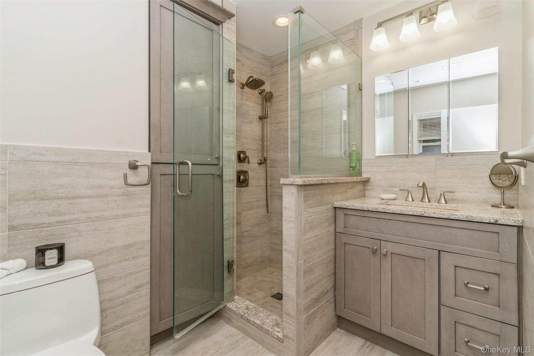 262 Channon Road Hewlett, NY 11557 - Photo 24 of 27 a bathroom with a granite countertop sink mirror and shower