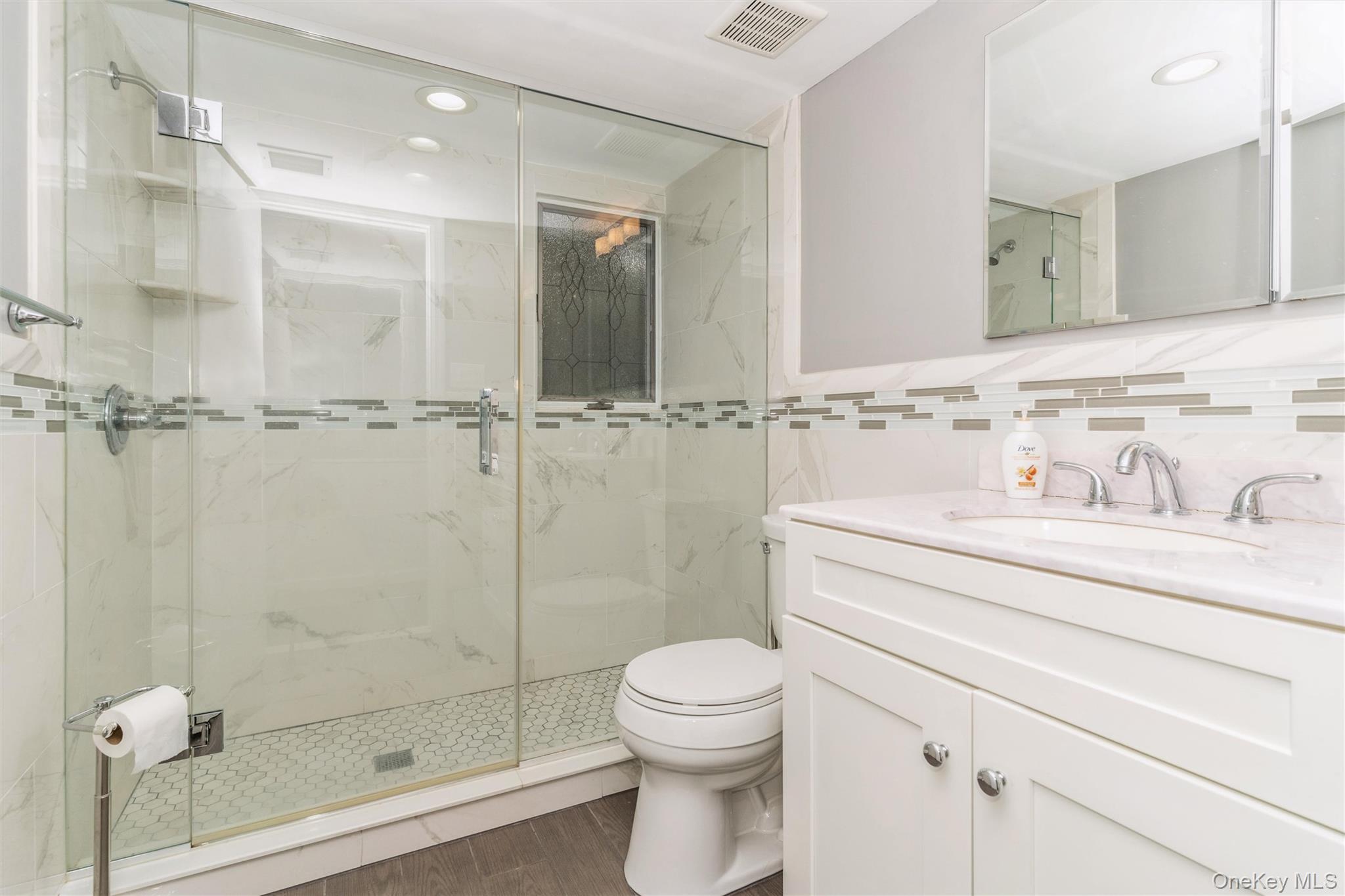 262 Channon Road Hewlett, NY 11557 - Photo 26 of 27 a bathroom with a shower a toilet and sink