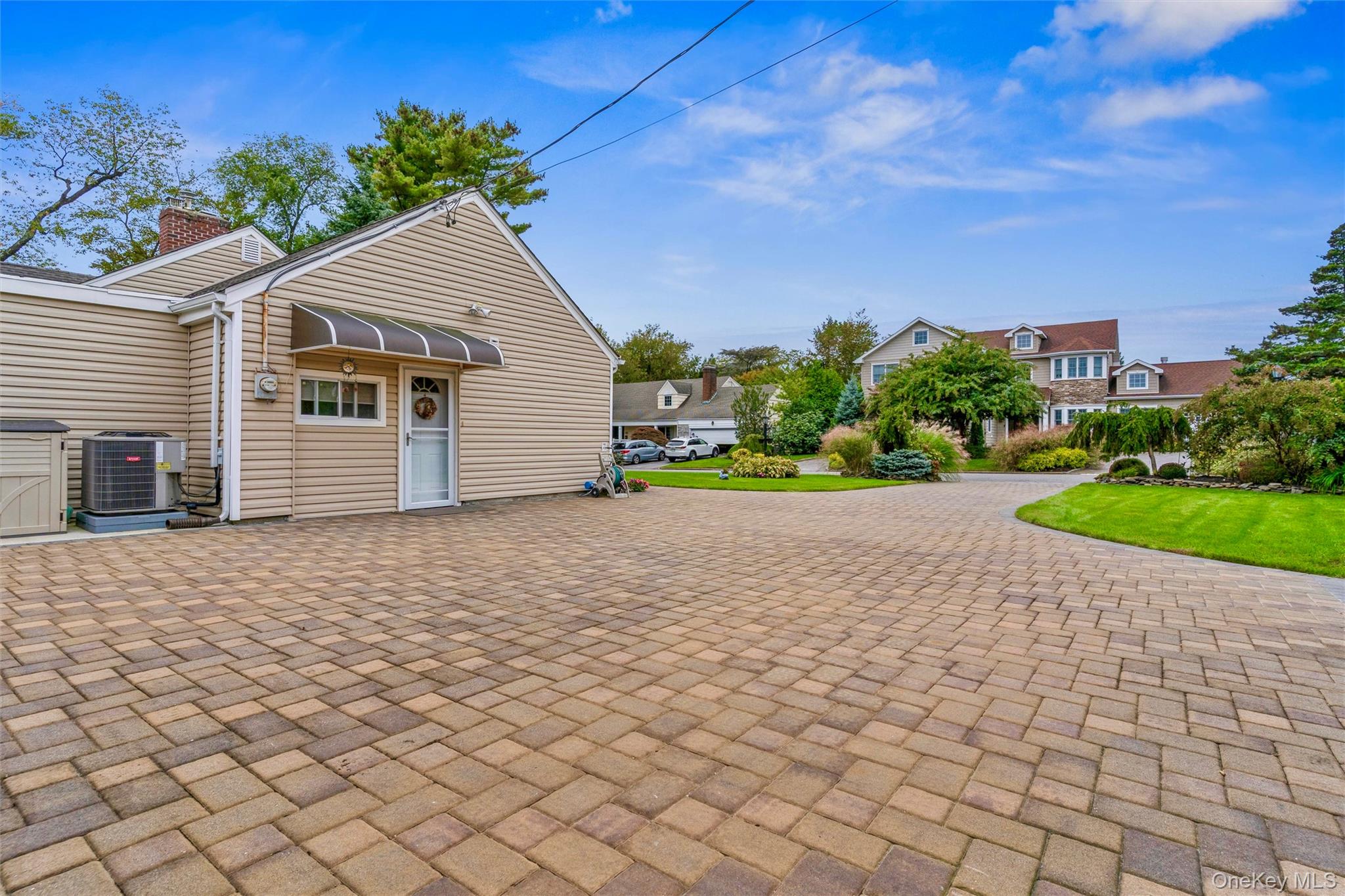 262 Channon Road Hewlett, NY 11557 - Photo 7 of 27 a backyard of a house with plants and trees