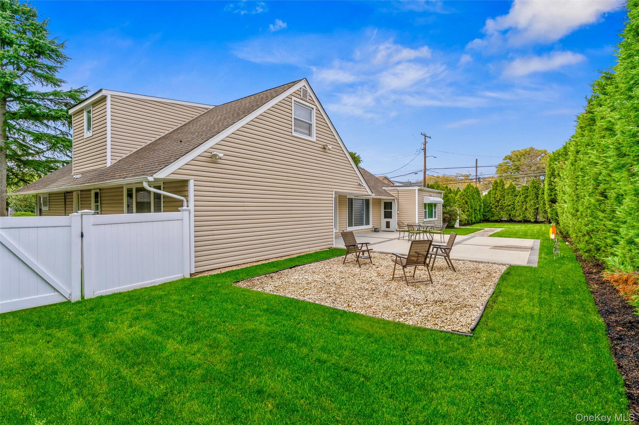 262 Channon Road Hewlett, NY 11557 - Photo 8 of 27 a view of a backyard with table and chairs and a fire pit
