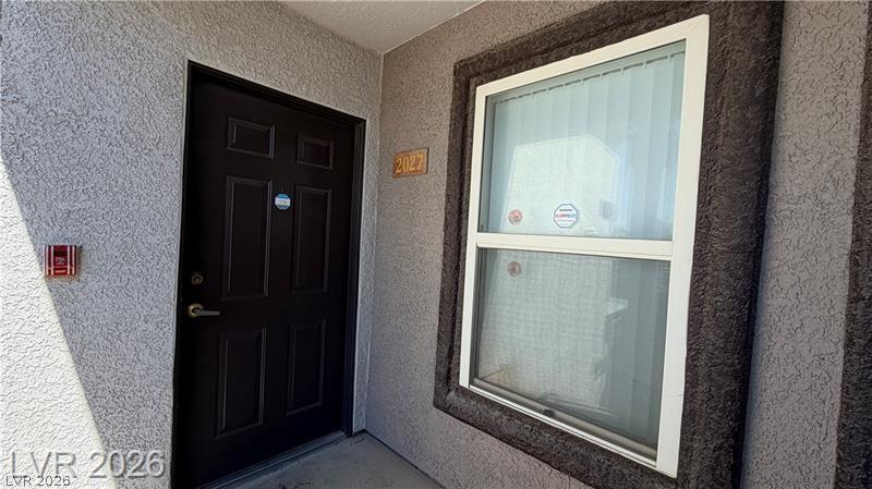 7255 West Sunset Road, Unit 2027 Las Vegas, NV 89113 - Photo 3 of 38 Textured stucco walls frame the secure private entrance of this residence.